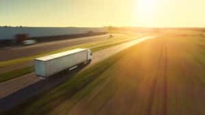 Aerial Follow Shot of White Semi Truck with Cargo Trailer Attached