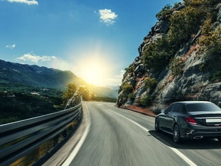 Black car rushing along a high-speed highway