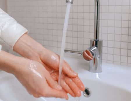 person washing hands to prevent spread of illness