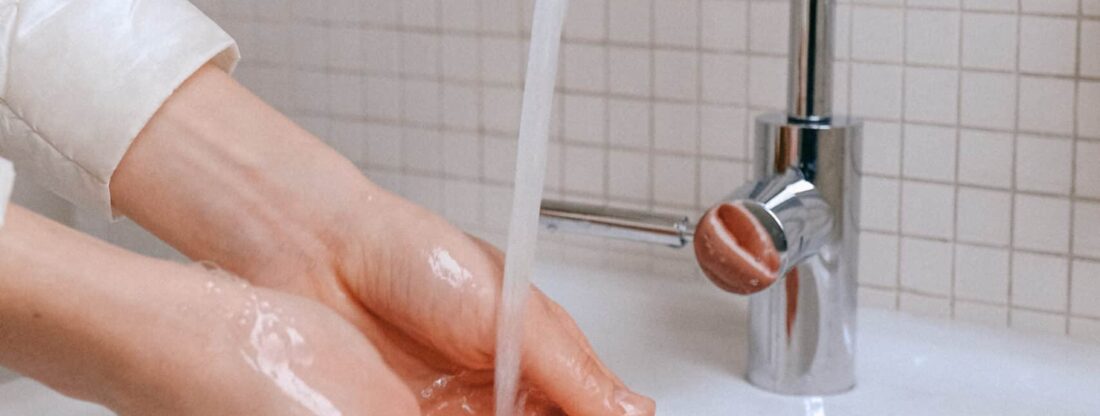 person washing hands to prevent spread of illness