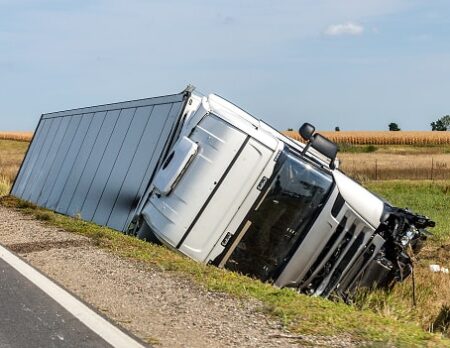 The truck lies in a side ditch after the road accident